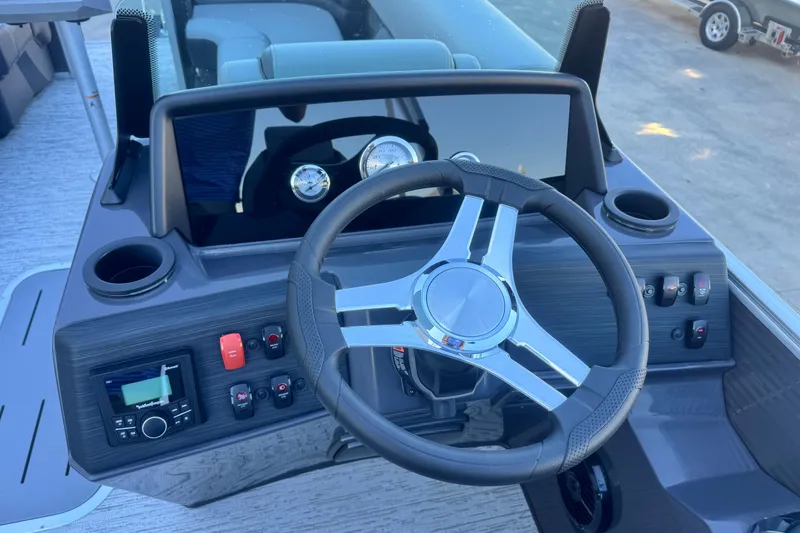 Slide: The Image of 2026 Bennington 23 SSR boat dashboard with steering wheel and control panel. - 14