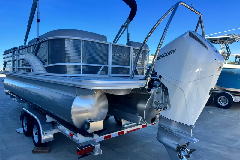 Slide: The Image of 2026 Bennington 23 SSR pontoon boat with Mercury outboard engine on trailer. - 4