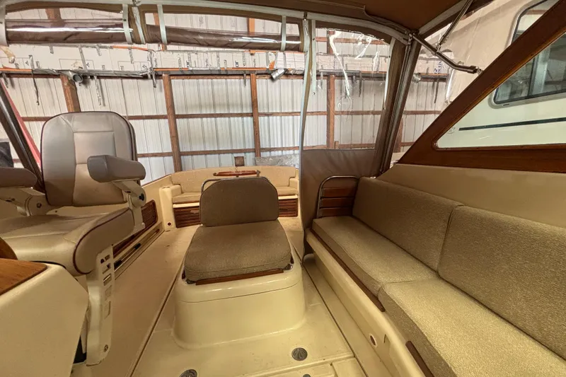 Slide: The Image of Interior of 2005 C.W. Hood Katama 30 boat, featuring beige seating and wood accents. - 11