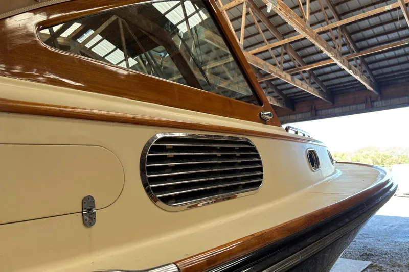 Slide: The Image of 2005 C.W. Hood Katama 30 boat in a wooden boathouse, showcasing elegant design details. - 21