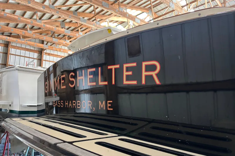 Slide: The Image of 2005 C.W. Hood Katama 30 boat in a wooden boathouse, Bass Harbor, ME. - 22