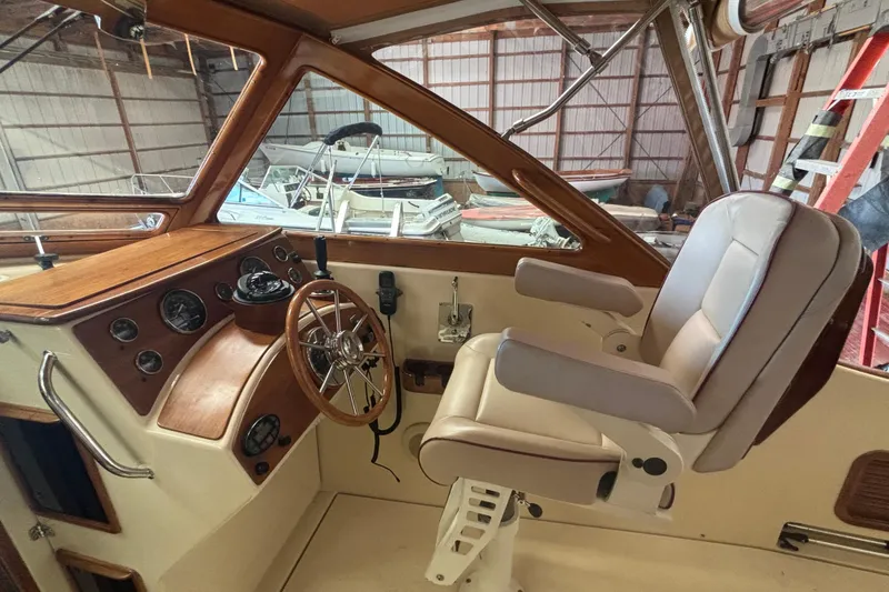 Slide: The Image of Helm of 2005 C.W. Hood Katama 30 with wooden dashboard and leather captain's chair. - 4