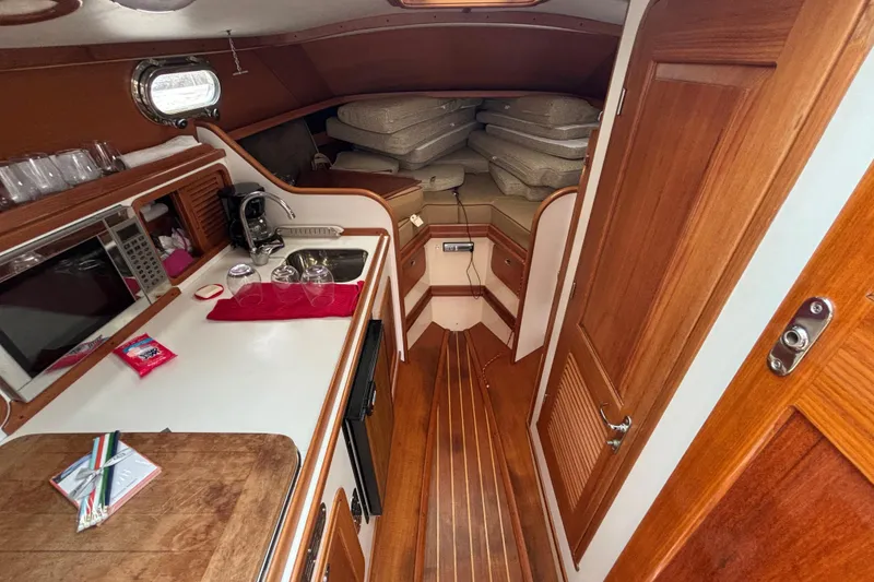 Slide: The Image of Interior of 2005 C.W. Hood Katama 30 boat with kitchenette and cozy cabin space. - 8
