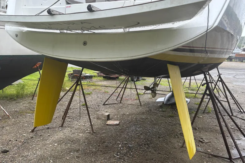 Slide: The Image of 2017 Jeanneau Sun Odyssey 389 sailboat on stands, showing yellow keels and propeller. - 10