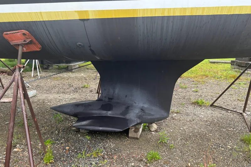 Slide: The Image of 2017 Jeanneau Sun Odyssey 389 sailboat keel on dry dock, supported by stands. - 11