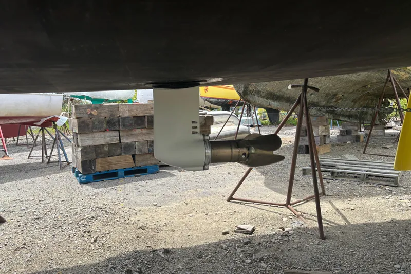 Slide: The Image of Propeller of 2017 Jeanneau Sun Odyssey 389 sailboat on dry dock, surrounded by supports. - 14