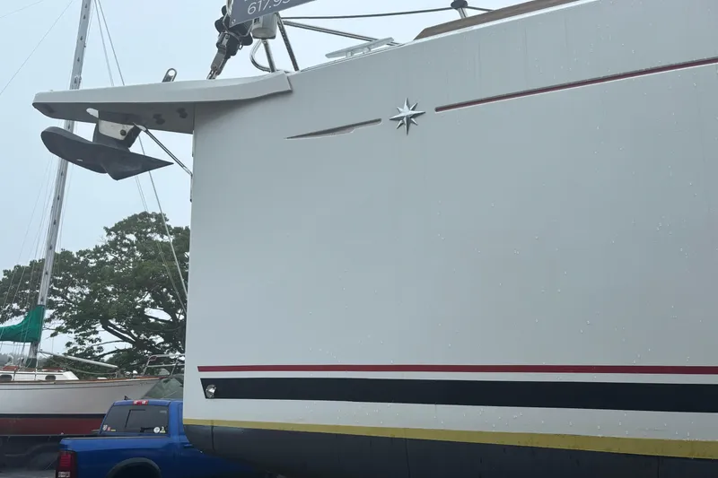 Slide: The Image of 2017 Jeanneau Sun Odyssey 389 sailboat with anchor, docked outdoors. - 16