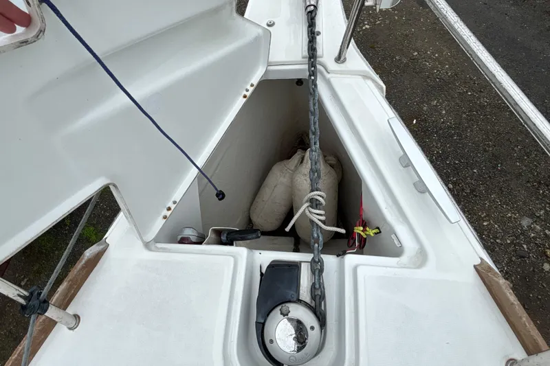Slide: The Image of Anchor locker of 2017 Jeanneau Sun Odyssey 389 sailboat with chain and fenders. - 24