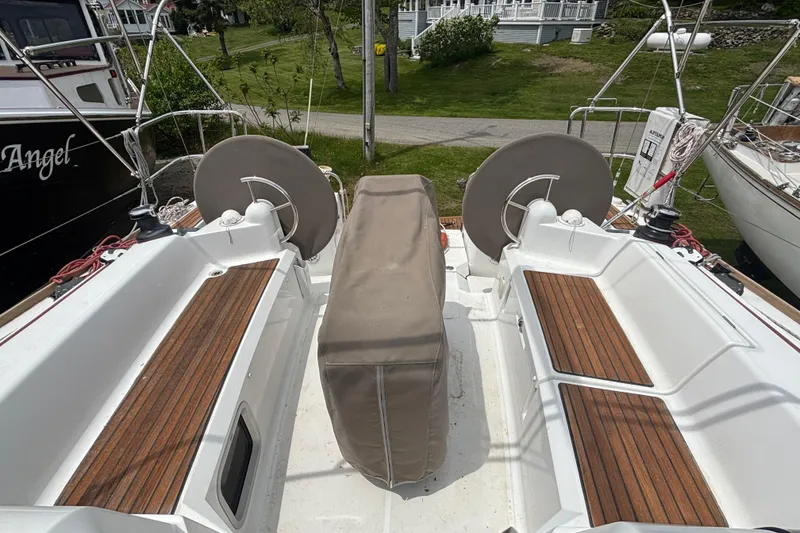 Slide: The Image of 2017 Jeanneau Sun Odyssey 389 cockpit with wooden seating and covered steering wheel. - 32