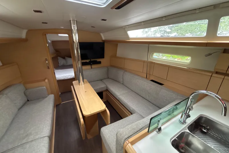 Slide: The Image of Interior of 2017 Jeanneau Sun Odyssey 389 yacht with modern seating and kitchenette. - 36