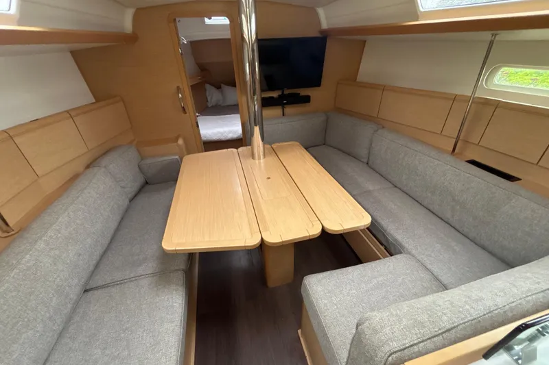 Slide: The Image of Interior of 2017 Jeanneau Sun Odyssey 389 sailboat with cozy seating and wooden table. - 39