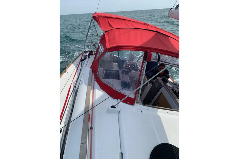Slide: The Image of 2017 Jeanneau Sun Odyssey 389 sailing with red canopy on open sea. - 4