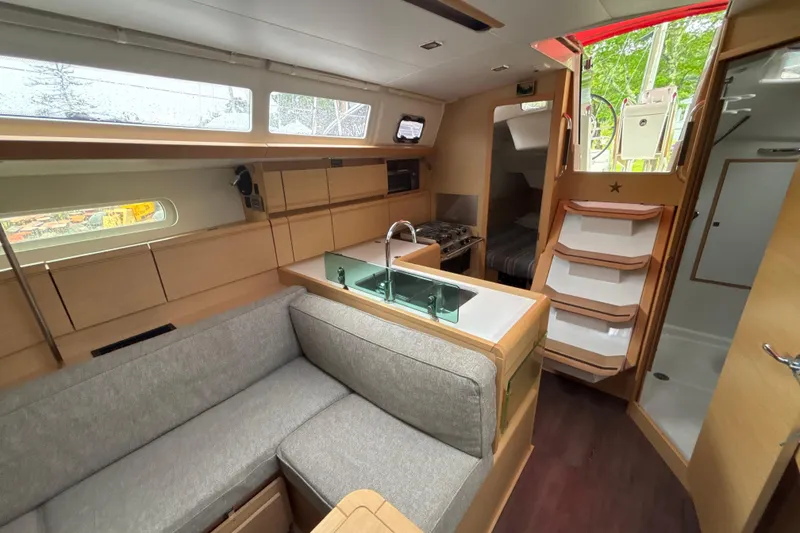 Slide: The Image of Interior of 2017 Jeanneau Sun Odyssey 389 yacht with modern kitchen and seating area. - 40