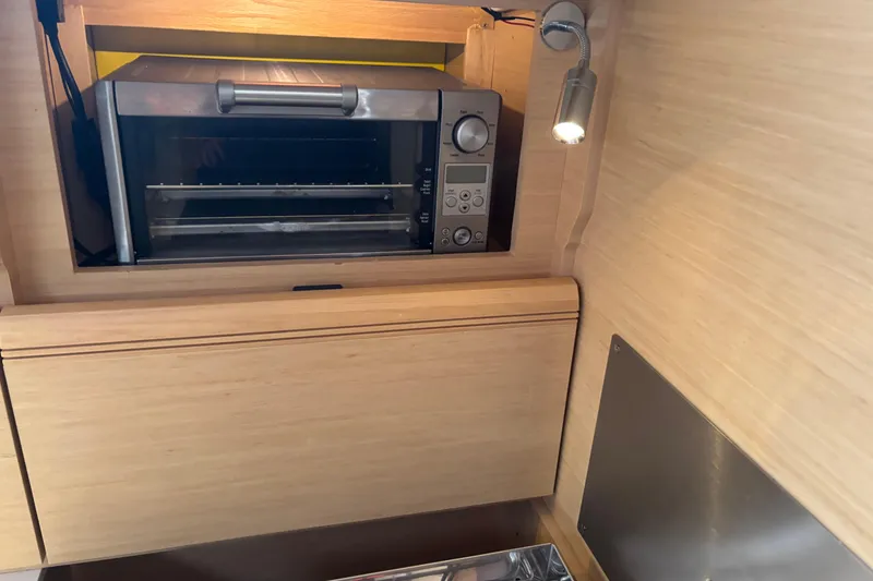 Slide: The Image of Compact kitchen area in 2017 Jeanneau Sun Odyssey 389 sailboat with built-in oven. - 44