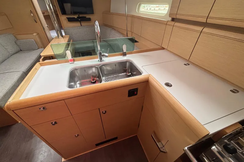Slide: The Image of Modern kitchen interior of 2017 Jeanneau Sun Odyssey 389 yacht with sleek cabinetry. - 46