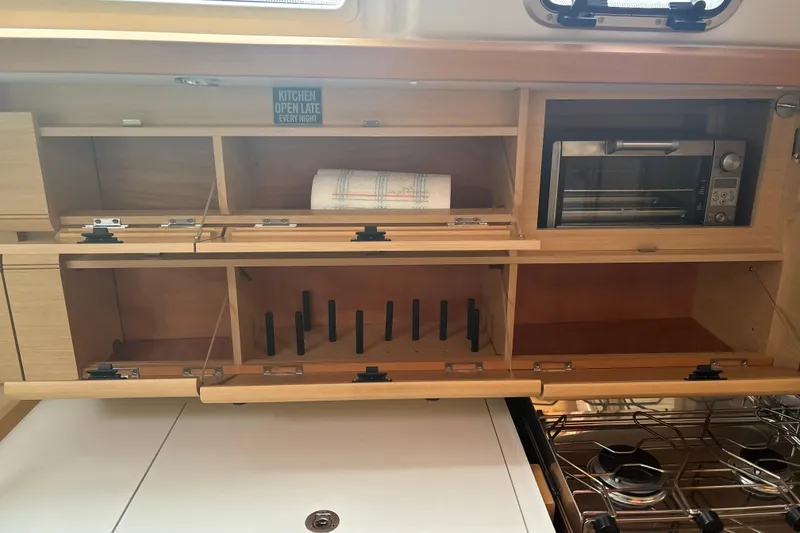 Slide: The Image of Interior of 2017 Jeanneau Sun Odyssey 389 yacht kitchen with wooden cabinets and appliances. - 47