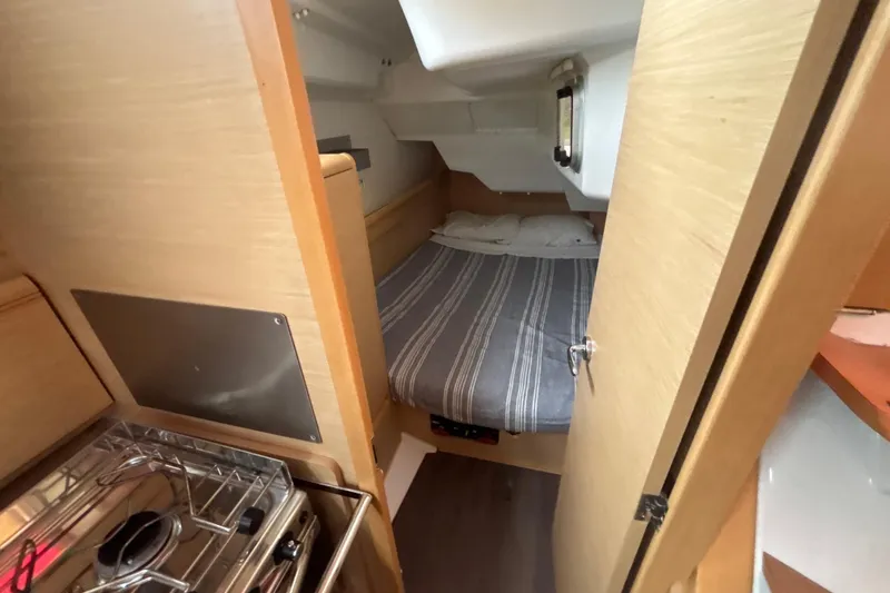 Slide: The Image of Cozy cabin interior of 2017 Jeanneau Sun Odyssey 389 sailboat with bed and compact kitchen. - 48