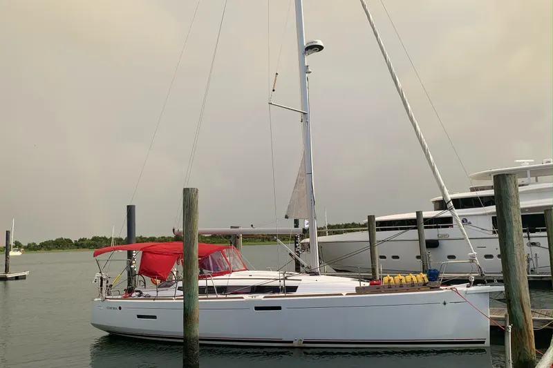 Slide: The Image of 2017 Jeanneau Sun Odyssey 389 sailboat docked with red canopy. - 5
