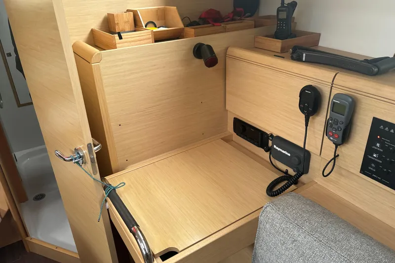 Slide: The Image of Interior of 2017 Jeanneau Sun Odyssey 389 yacht with navigation equipment and wooden cabinetry. - 50