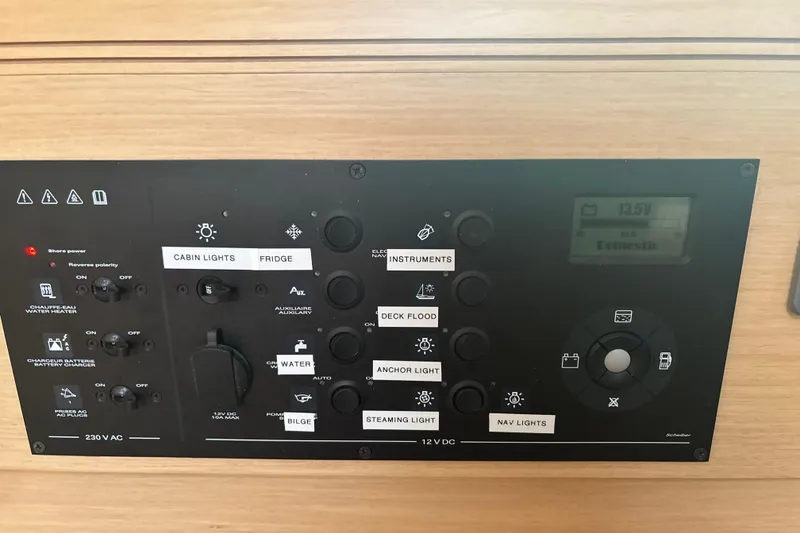 Slide: The Image of Control panel of a 2017 Jeanneau Sun Odyssey 389 sailboat, featuring various switches and indicators. - 51