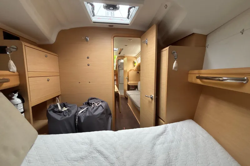 Slide: The Image of 2017 Jeanneau Sun Odyssey 389 interior cabin with wood finish and storage compartments. - 58