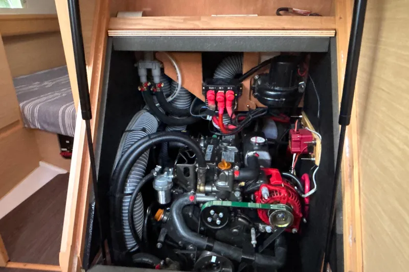 Slide: The Image of Engine compartment of 2017 Jeanneau Sun Odyssey 389 sailboat, showcasing mechanical components. - 59