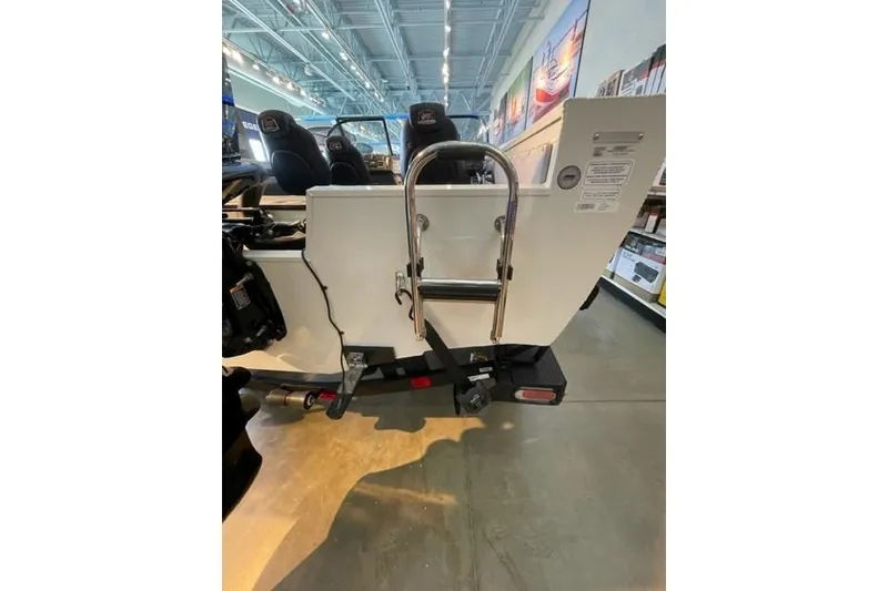Slide: The Image of 2024 Ranger VX1988 WT boat rear view with ladder in showroom. - 111