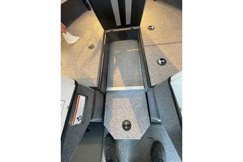 Slide: The Image of 2024 Ranger VX1988 WT boat interior with carpeted flooring and storage compartments. - 118