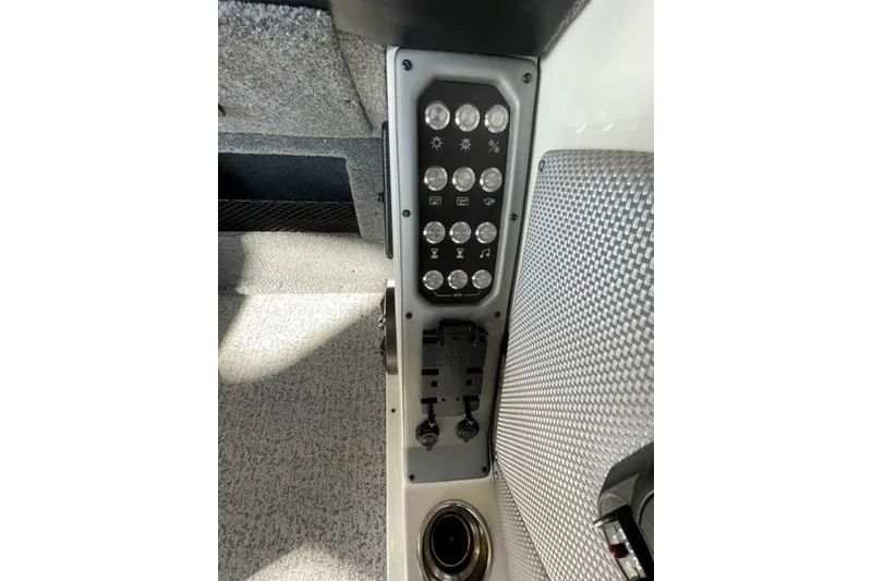 Slide: The Image of Control panel of 2024 Ranger VX1988 WT boat with switches and cup holder. - 121