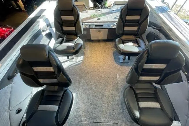 Slide: The Image of 2024 Ranger VX1988 WT boat interior with four black seats and carpeted floor. - 13