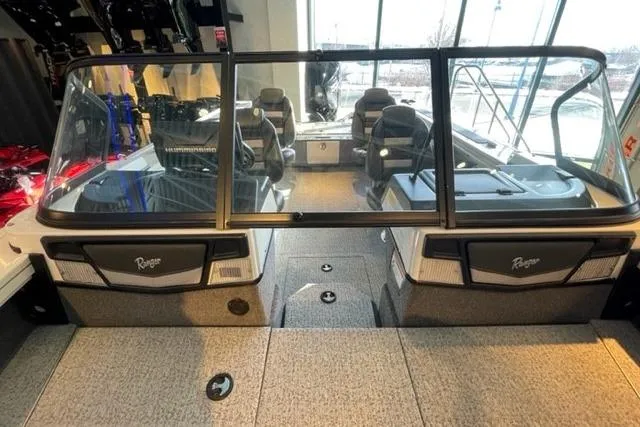 Slide: The Image of 2024 Ranger VX1988 WT boat interior with seating and windshield in showroom. - 18