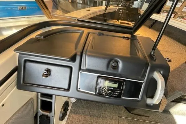 Slide: The Image of 2024 Ranger VX1988 WT boat dashboard with control panel and storage compartments. - 21