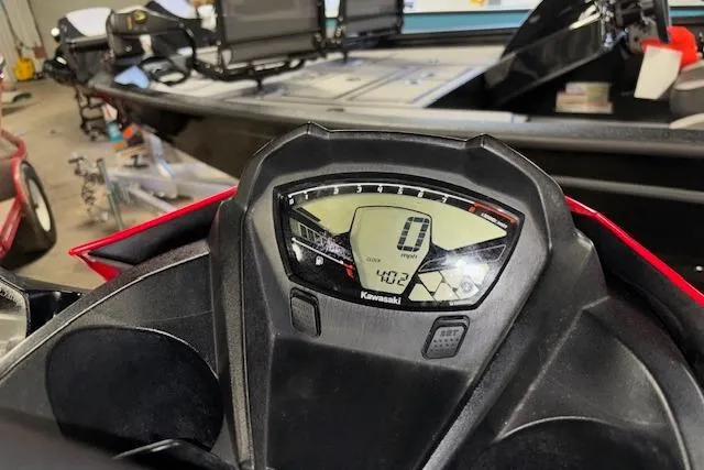 Slide: The Image of Dashboard of a 2021 Kawasaki Jetski STX 160 in a garage setting. - 10