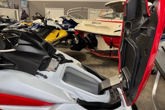 Slide: The Image of 2021 Kawasaki Jetski STX 160 with open storage compartment in a showroom. - 11