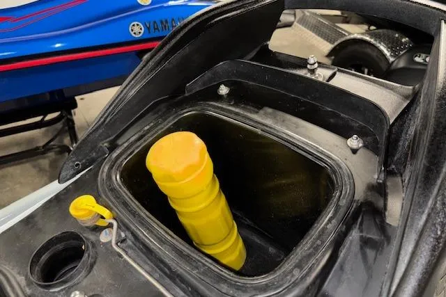 Slide: The Image of 2021 Kawasaki Jetski STX 160 storage compartment with yellow cap, close-up view. - 16