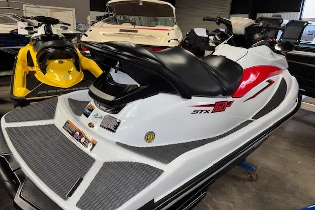 Slide: The Image of 2021 Kawasaki Jetski STX 160 in showroom, white with red accents, side view. - 3