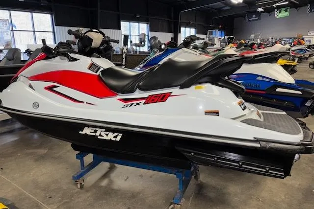Slide: The Image of 2021 Kawasaki Jetski STX 160 in showroom, white and red design, side view. - 4