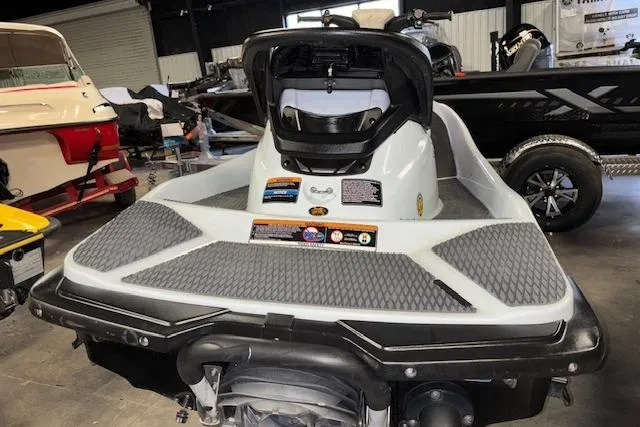 Slide: The Image of 2021 Kawasaki Jetski STX 160 in showroom, rear view with open seat compartment. - 8