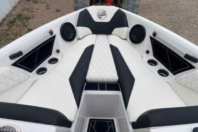 Slide: The Image of 2023 Tigé Z3 boat interior with white and black seating, speakers, and cup holders. - 10