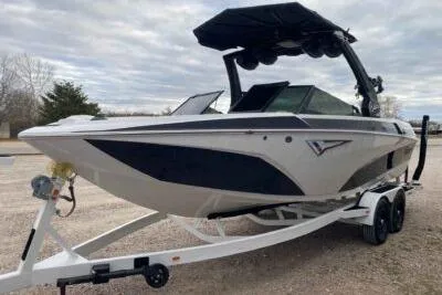 Slide: The Image of 2023 Tigé Z3 boat on trailer, sleek design, black and white color scheme. - 2