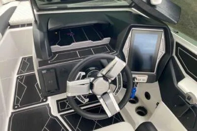 Slide: The Image of 2023 Tigé Z3 boat dashboard with modern steering wheel and touchscreen controls. - 7