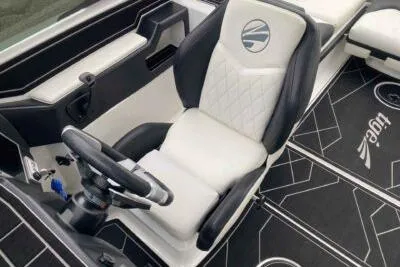 Slide: The Image of 2023 Tigé Z3 boat interior with sleek black and white seating and modern steering wheel. - 8