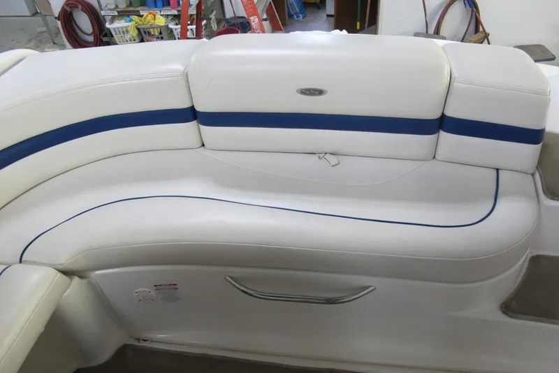 Slide: The Image of 2003 Chaparral 280 SSi boat interior with white and blue cushioned seating. - 12