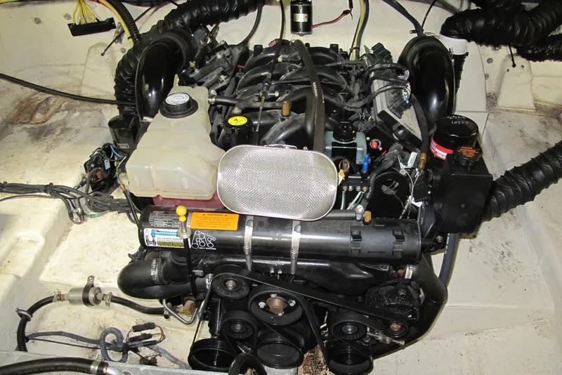 Slide: The Image of Engine compartment of a 2003 Chaparral 280 SSi boat, showcasing mechanical components. - 14