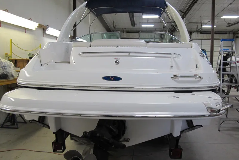 Slide: The Image of 2003 Chaparral 280 SSi boat in a workshop, rear view with swim platform. - 2