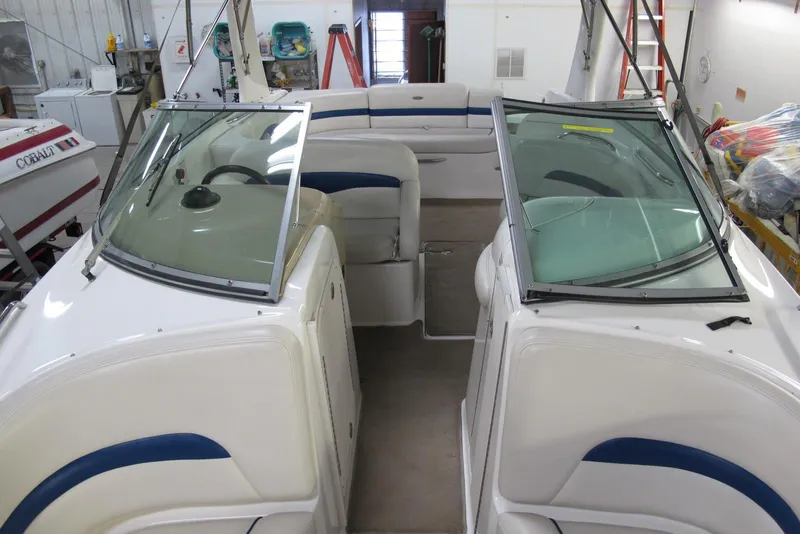 Slide: The Image of 2003 Chaparral 280 SSi boat interior with dual windshields in a storage facility. - 4