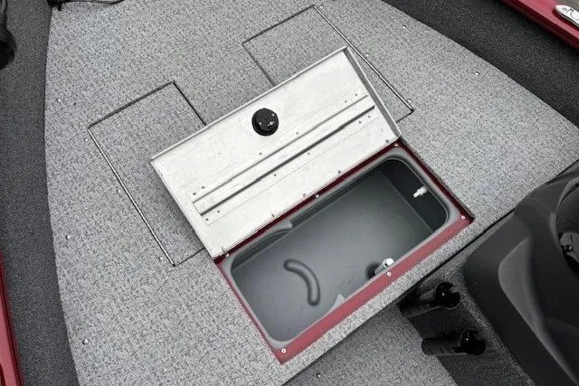 Slide: The Image of 2021 Tracker Super Guide V-16 SC boat storage compartment with open lid on carpeted deck. - 11