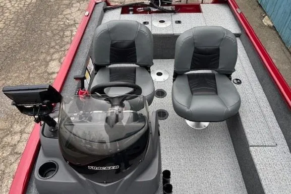 Slide: The Image of 2021 Tracker Super Guide V-16 SC boat interior with dual seats and steering console. - 12
