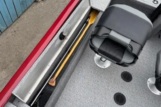 Slide: The Image of 2021 Tracker Super Guide V-16 SC boat interior with seat and storage compartment. - 17