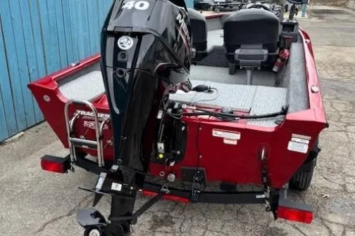 Slide: The Image of 2021 Tracker Super Guide V-16 SC boat with 40 HP engine, red exterior, parked outdoors. - 4